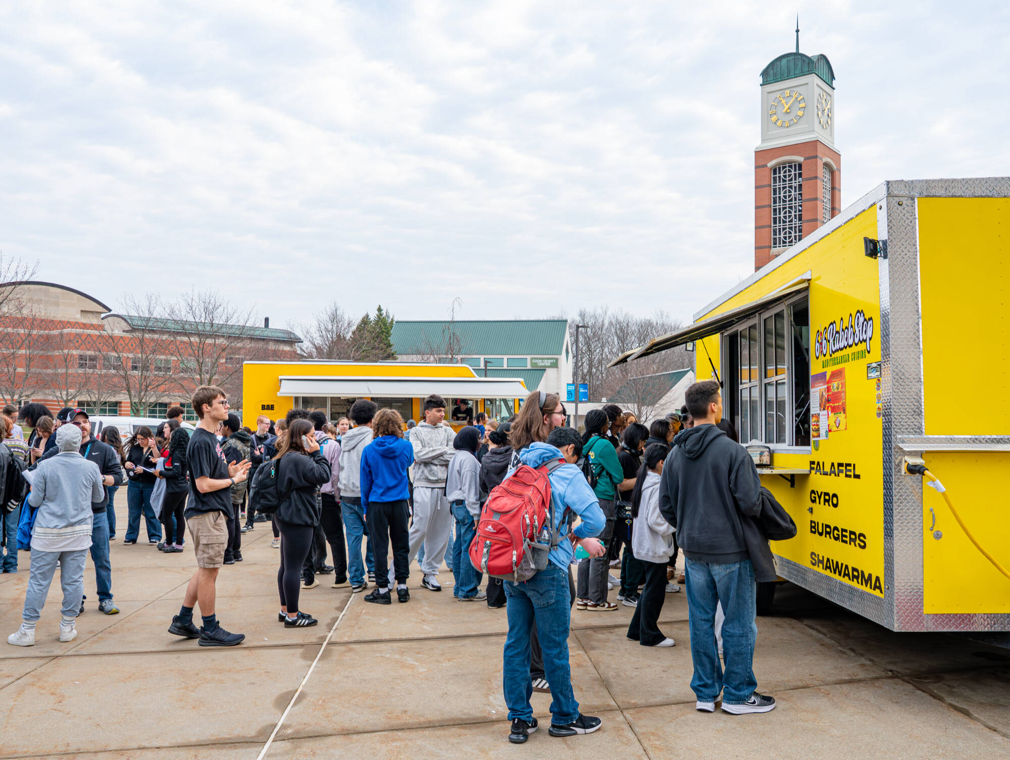 Students in line outside at the food trucks